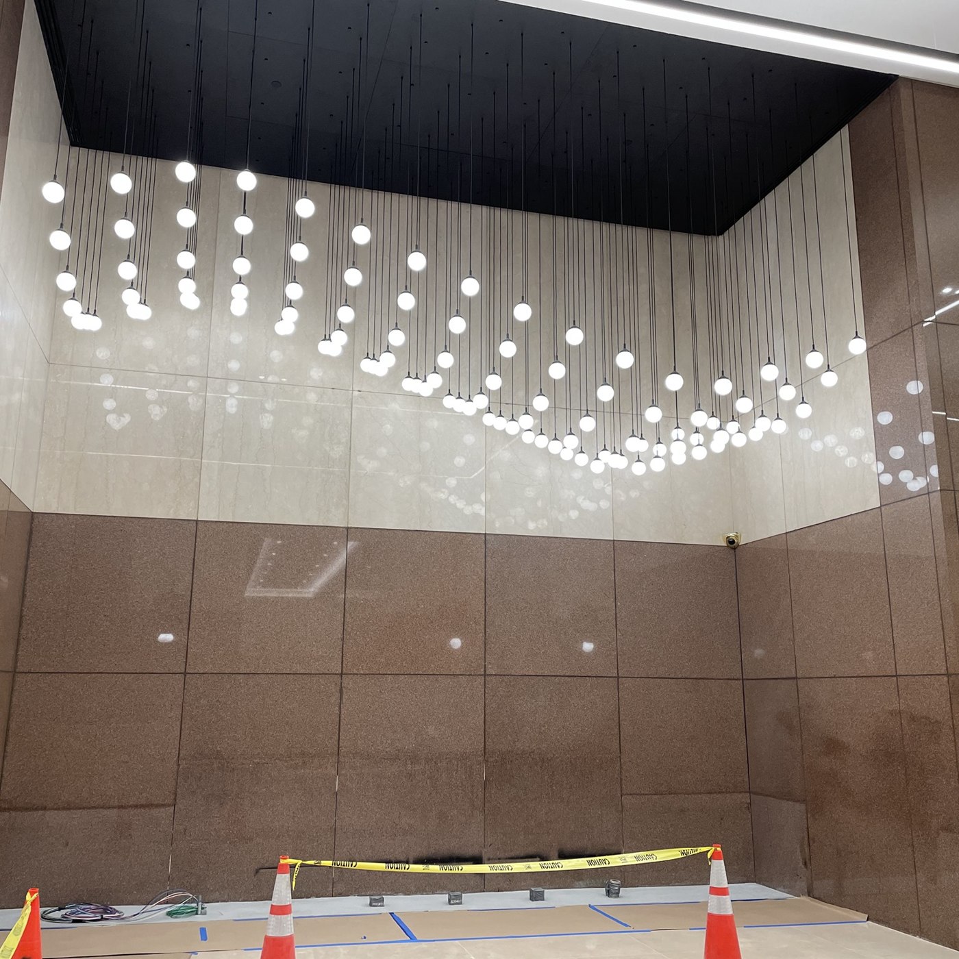 Custom decorative pendant lighting installation forming an art wall